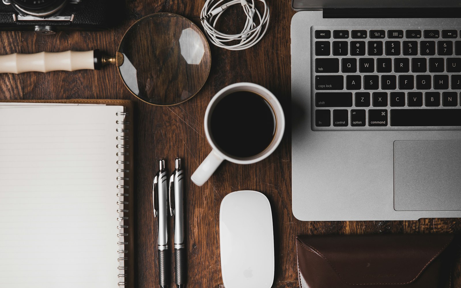 Cup of coffee beside a laptop on a desk